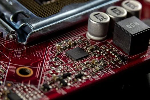 a computer processor chip held between fingertips above a motherboard socket, macro shot, cool studio lighting, tech editorial photography