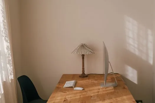 a tidy home office desk with a compact 75 percent mechanical keyboard and a mouse, morning window light, minimal clean setup, editorial photography, shallow depth of field