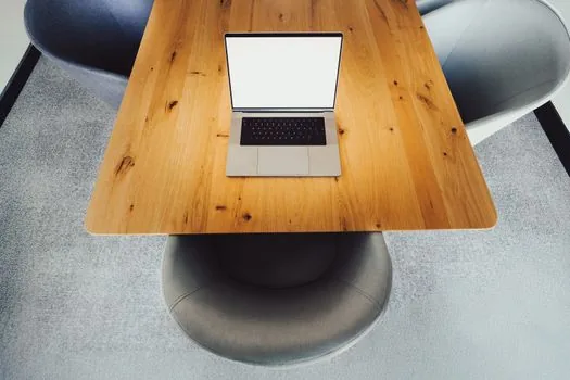 laptop on clean desk showing official Discord download page with operating system buttons
