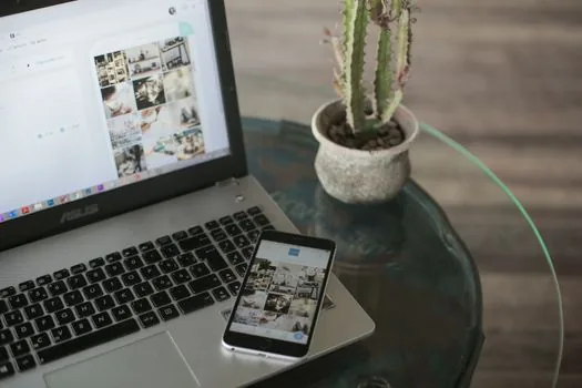 online smartphone launch event livestream on laptop and phone, clean tech desk, no brand logos