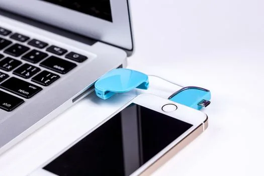 simple checklist on laptop screen for iphone photo conversion, smartphone and usb cable on table