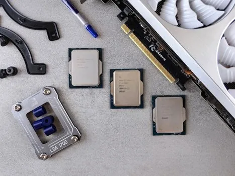 two boxed desktop cpu processors placed side by side on a wooden desk, one red-themed one blue-themed packaging, soft window light, product comparison photography