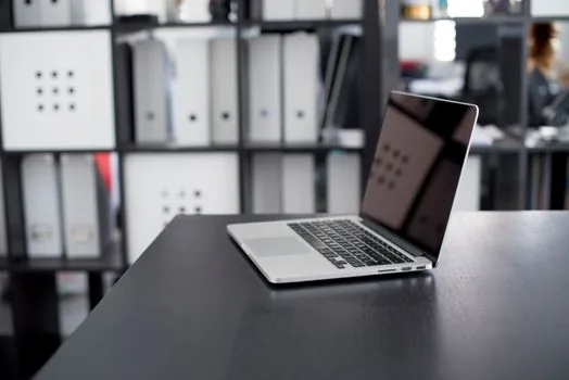 windows laptop showing photo import folder with heic and jpg file labels, neutral modern workspace