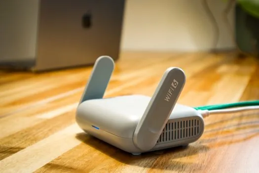 Android phone and Windows 11 laptop on same home Wi-Fi network beside router, user checking network names, realistic bright desk | PC와 휴대폰의 같은 Wi-Fi 연결을 확인하는 장면