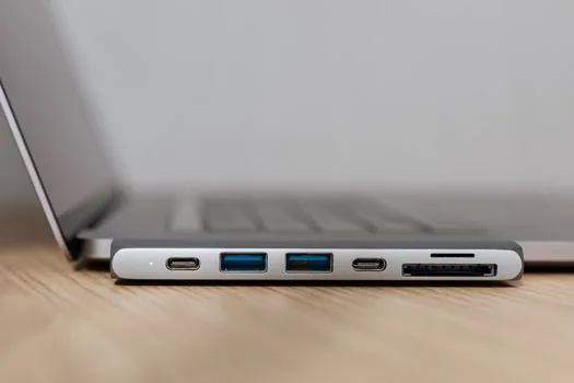 Android phone connected to Windows laptop with USB-C cable while file explorer is open, realistic desk setup