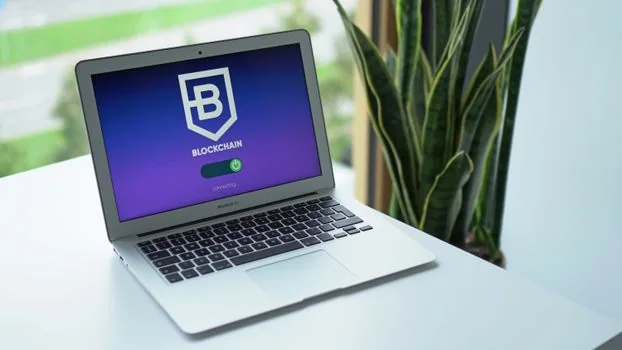 close-up of hardware security key beside laptop login approval screen and security policy document, realistic editorial photo | 하드웨어 보안키와 접근 정책을 함께 확인하는 장면