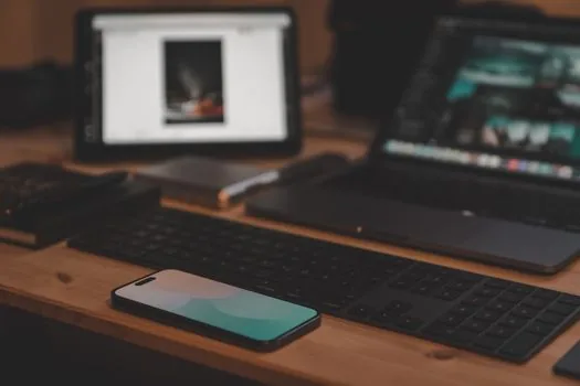 Korean Android phone and Windows laptop on desk showing nearby file sharing screen, bright realistic photo