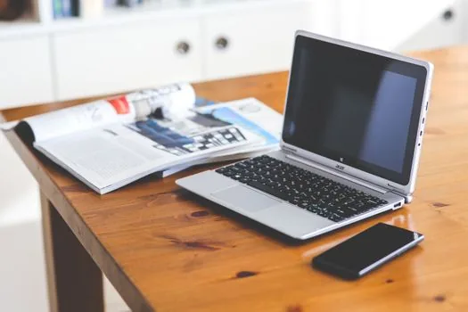 Korean user opening Chrome Remote Desktop official access page on laptop, smartphone ready for remote connection, realistic tech desk photo