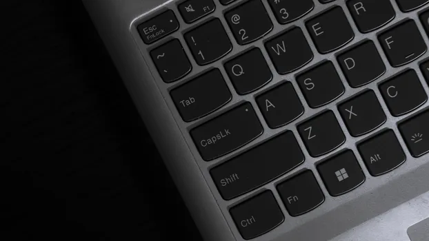 person using laptop account recovery page with phone missing checklist, spare notebook and security key on desk, calm realistic editorial photo, no readable private data | 휴대폰 분실 뒤 다른 로그인 방법을 찾는 장면
