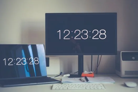 Windows 11 display orientation settings on 2-in-1 laptop with external monitor beside it