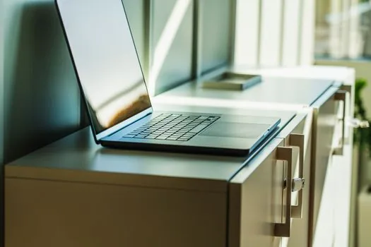 Windows 11 File Explorer open to Videos Captures folder on a laptop, MP4 video files visible as generic thumbnails without readable text, neat desk setup, soft daylight, editorial photography