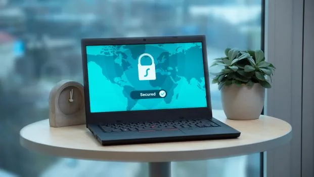 Windows 11 laptop showing Windows Security App and browser control settings with blocked installer warning