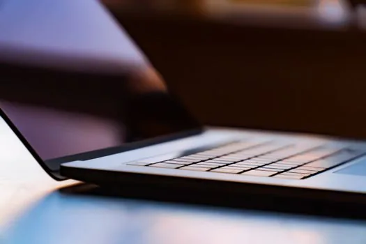 Windows 11 laptop Wi-Fi settings screen showing connected home network and password reveal area, clean practical tech photo