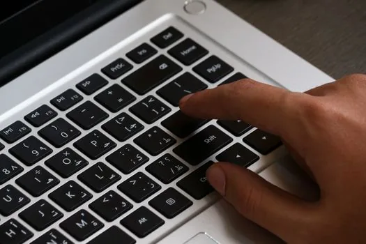 Windows 11 snap layout menu opened from maximize button, user choosing two-column layout, realistic laptop close-up without brand logo