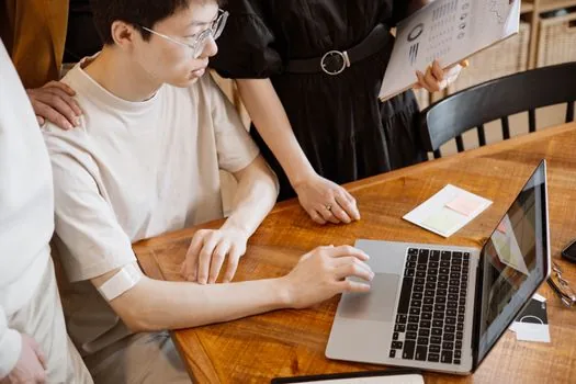 person reviewing Windows task manager startup apps on laptop