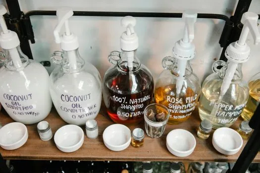 smartphone showing official product page price and sold-out label while user compares shampoo size on bathroom shelf, realistic product buying scene | 공식 상품 페이지의 가격·용량·품절 상태를 확인하는 장면