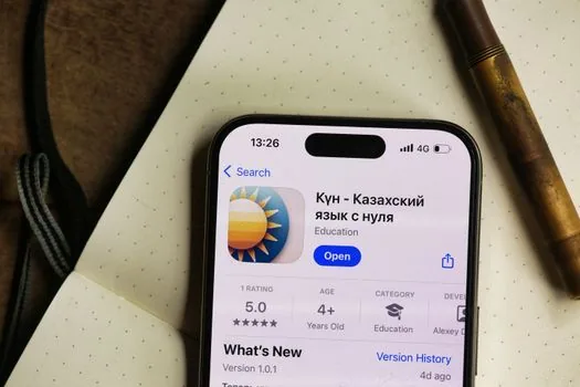 unlocked iPhone Photos iCloud settings screen on a desk beside a Windows laptop, user checking original download option, realistic photo