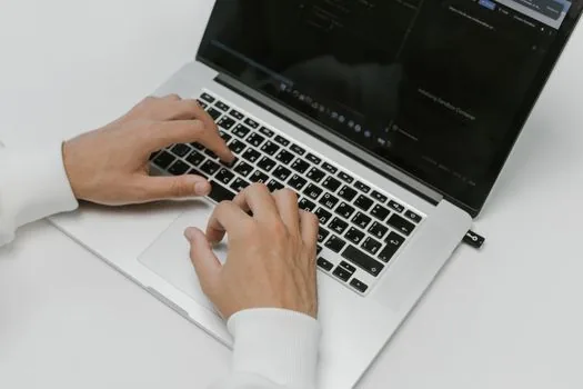 Windows 11 laptop keyboard with user pressing Windows key and period while a text field is active, realistic bright desk photo | 이모지 패널 단축키를 테스트하는 장면
