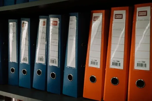 Windows File Explorer showing iCloud Photos folder and a separate backup folder on external SSD, practical desk photo