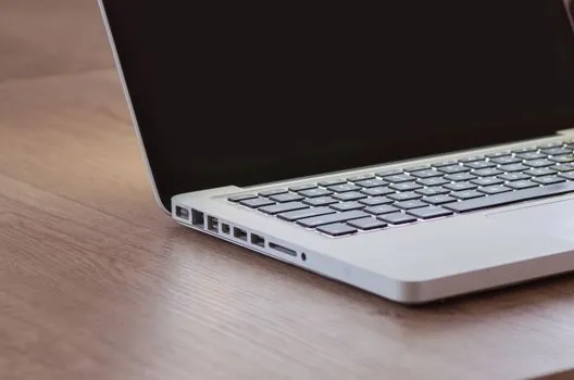 Windows laptop sign-in screen with password field and recovery options on a clean desk